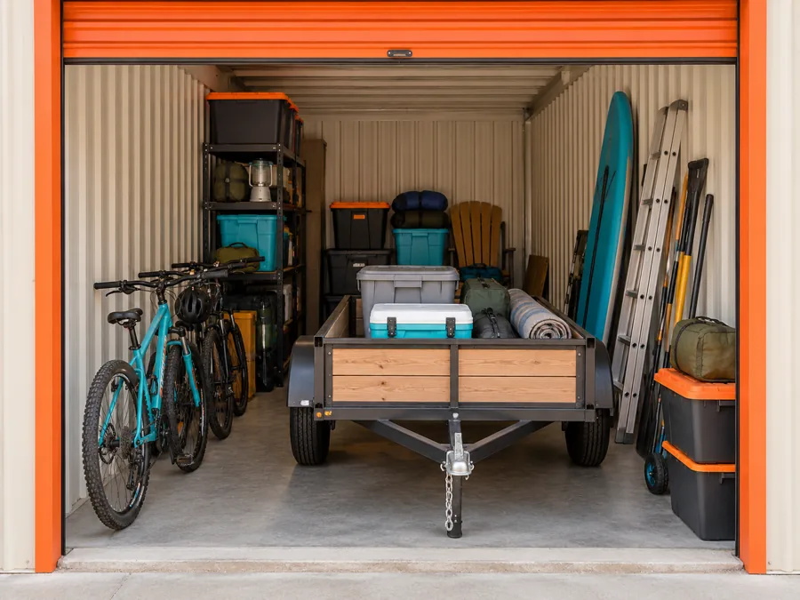 Illustration: Small utility trailer, bicycles and seasonal gear in a long storage space